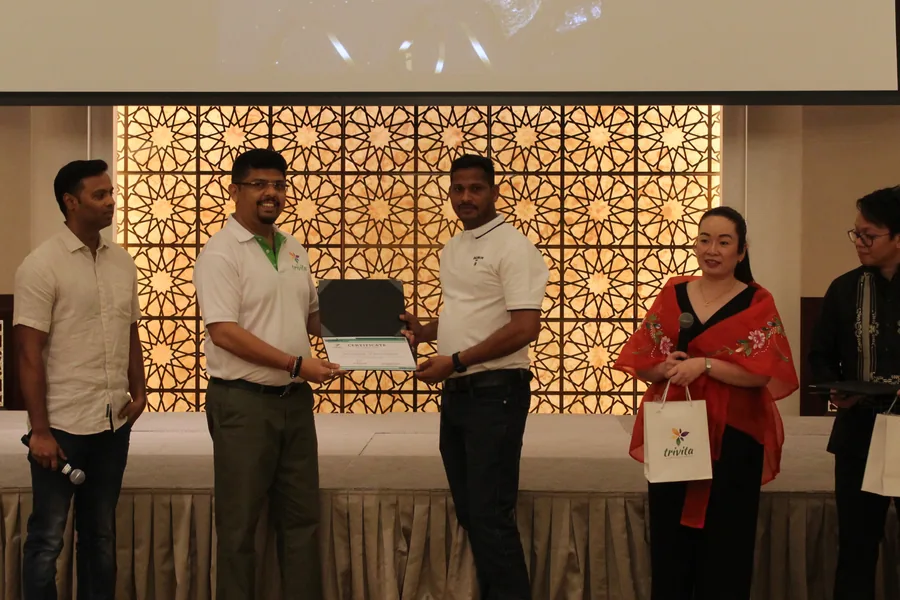 A Trivita colleague being presented with an award